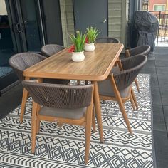 a wooden table sitting on top of a rug