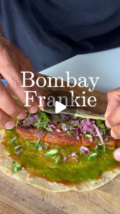 someone is cutting up some food on top of a wooden board with the words bomb bay frakie above it