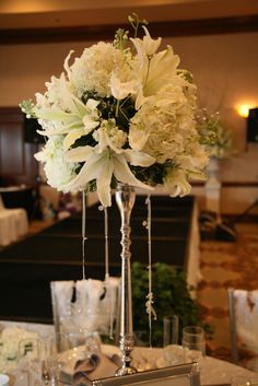 several different pictures of flowers in vases and on tables at a wedding or other function