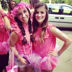 two girls dressed in pink posing for the camera