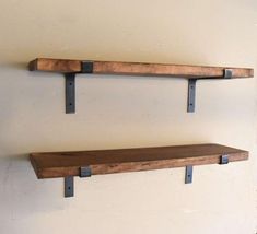 two wooden shelves with metal brackets on them