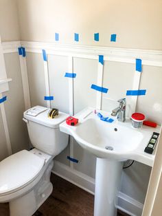 a bathroom with blue tape on the walls