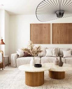 a living room with two couches and a coffee table in front of the wall