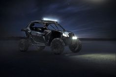 a can - am rzr in the dark with its lights on