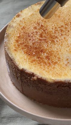 a cake is being cut on a plate with a large spatula in it's center