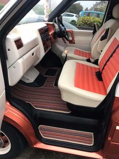 the interior of a car with red and white seats