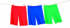 three different colored pants hanging on a clothes line, one is green, the other is red