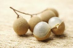 some kind of fruit sitting on top of a piece of burlied fabric with leaves