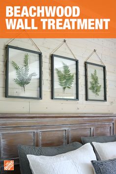 a bed with three framed pictures hanging on the wall above it, along with two pillows