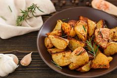 a brown plate topped with potatoes and garlic