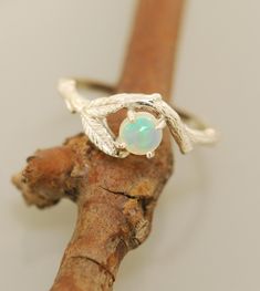 Twin Leaf Opal Ring Original Design Made in the USA A beautiful 5 mm opal sits under a curved branch in this ring. Two leaves rest along side in this ring for the nature loving types. The ring is all sterling silver. The opal is ethiopan and grade AAA. If you want a different stone or metal choice please email me. Engagement Ring Opal, Engagement Ring Alternative, Etsy Engagement Rings, Antler Ring, Twig Ring, Alternative Engagement Ring, Leaf Engagement Ring, Rose Gold Flower, Branch Ring