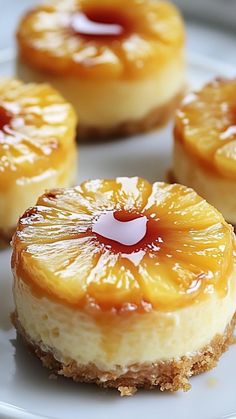 three pineapple cheesecakes on a white plate with caramel sauce in the middle