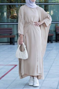 Experience effortless elegance with the Janeti Linen Natural Fabric 3 Piece Set from Annah Hariri. Made from the lightest linen fabric, this set features a long sleeve inner slip dress, an adjustable apron, and an open front abaya in timeless beige. With its versatile design, the apron can be styled in three different ways, while the abaya provides modest coverage. Choose the perfect size for you with the size chart provided and enjoy a longer length with L or XL. With its timeless fabric and co Silk Hijab Dress, Silk Hijab, Modest Activewear, Full Coverage Swimsuit, Dress Abaya, Dress Apron, Wooden Crosses, Muslim Fashion Outfits, Abaya Dress