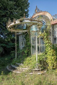 an old, run down gazebo with vines growing around it