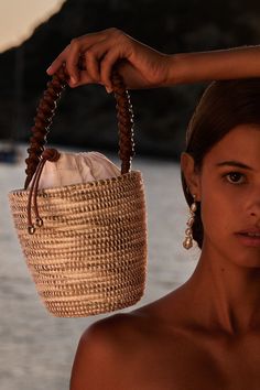 A luxe, take on the bag that started it all - our signature Lunchpail, now finished with an intricately hand-braided Napa Leather handle, from a centuries old Italian atelier, heralded for it’s world class quality and attention to details. Cesta baskets are handwoven by female artisans in Rwanda, Africa, using locally sourced, renewable resources. Each piece is hand finished in Italy with carefully chosen, sustainable materials. 6" W x 6.5" T x 6" D Leather: Camel Italian Nappa / Vegetable Tanne French Riviera Style, Rwanda Africa, Lunch Pail, Boho Bags, Jane Birkin, Gender Equality, Social Impact, Beach Photoshoot, Basket Bag