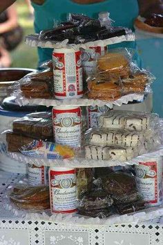 three tiered trays filled with donuts and pastries on top of a table