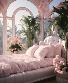 a large bed with pink sheets and pillows in a room filled with potted plants