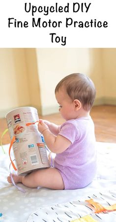 a baby sitting on the floor reading a book with text overlay that reads upcycled diy fine motor practice toy