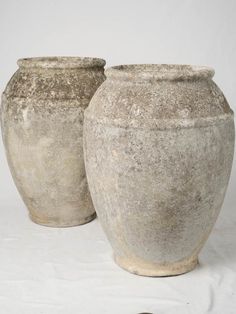 two cement pots sitting next to each other