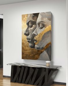 an abstract painting hangs on the wall next to a console