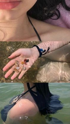 a woman with her hands in the water holding something up to her chest and looking at the camera