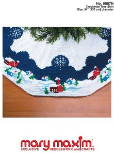 a crocheted christmas tree skirt with snowmen on it