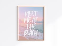 a framed poster with the words meet me at the beach