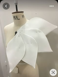 a mannequin with white fabric on it's torso