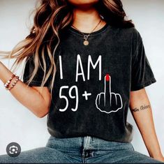 a woman wearing a black t - shirt that says i am 59 plus with a red lipstick on it