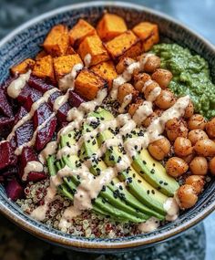 a bowl filled with different types of vegetables and sauces on top of each other