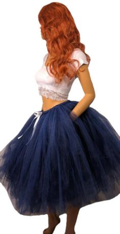 Step into elegance and grace with our Beautiful Navy Blue Tutu Skirt. This stunning skirt is perfect for any occasion, whether it's a special event, a party, or simply a day when you want to feel extra special. The skirt is meticulously crafted by tying hundreds of pieces of tulle to a comfortable elastic band. This technique creates a full and voluminous look, giving the skirt a mesmerizing and fluffy appearance. The deep navy blue color adds an element of sophistication, making you stand out with style and confidence. To add a touch of elegance, the skirt is adorned with a delicate white satin bow, creating a beautiful contrast against the navy blue tulle. This subtle detail adds an extra layer of charm and completes the overall look. Measuring at a length of 25 inches, this tutu skirt f Blue Tutu Skirt, Adult Tutu Skirt, Blue Tutu, Deep Navy Blue, Blue Tulle, White Bow, Satin Bow, Navy Blue Color, Tutu Skirt