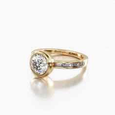 a yellow gold engagement ring with two diamonds