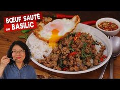 a woman holding a fork in front of a plate of food