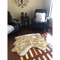 a living room with two chairs and a rug on the floor