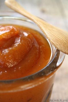 a small glass jar filled with sauce on top of a table