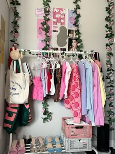 a closet filled with clothes and shoes next to a wall mounted art print on the wall