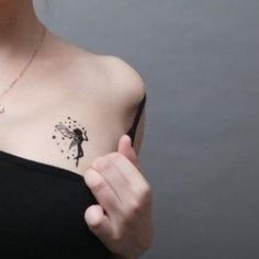 a woman with a small tattoo on her chest