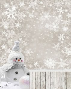 a snowman is standing in front of a wooden wall with white snowflakes on it