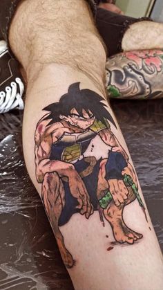 a man's leg with a dragon tattoo on it and an image of gohan