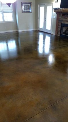 an empty living room with hard wood floors