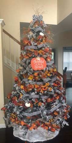 a decorated christmas tree with an orange and black heart on it's centerpiece