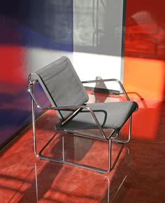 a chair sitting on top of a red floor next to a wall