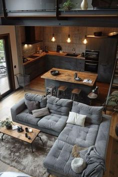 a living room filled with furniture next to a kitchen and an open concept floor plan