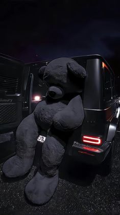 a large teddy bear sitting in the back of a truck