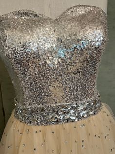 a dress with sequins is displayed on a mannequin