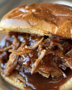 a pulled pork sandwich with barbecue sauce on it