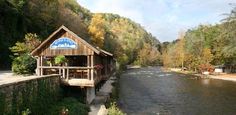 there is a small building on the side of the river