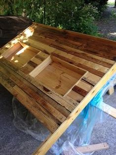 a table made out of pallet wood sitting on the ground