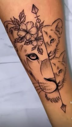 a tiger and lioness tattoo on the leg with flowers in it's head