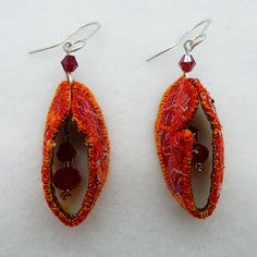 Colourful machine embroidered textile earrings in pinkish-red with golden orange edging. Finished with glass beads and sterling silver ear hooks. Textile Earrings, Pinkish Red, Lovely Earrings, Ear Hook, Jewelry Pieces, Jewelry Earrings Dangle, Glass Beads, Dangle Drop Earrings, Dangle Earrings